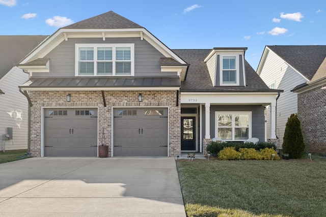 craftsman inspired home with concrete driveway, brick siding, and a standing seam roof