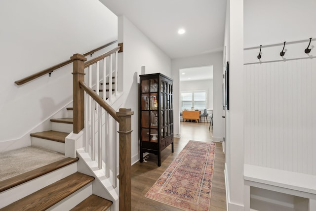 mudroom with wood finished floors and recessed lighting