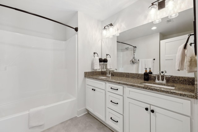 bathroom featuring shower / washtub combination, tile patterned flooring, a sink, and visible vents