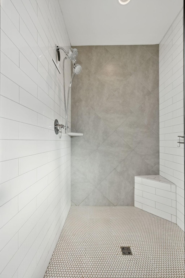 full bath with a tile shower