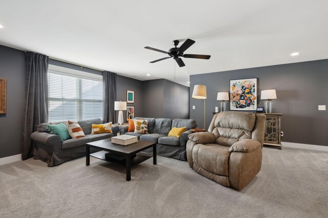 living area with baseboards, ceiling fan, recessed lighting, and light colored carpet