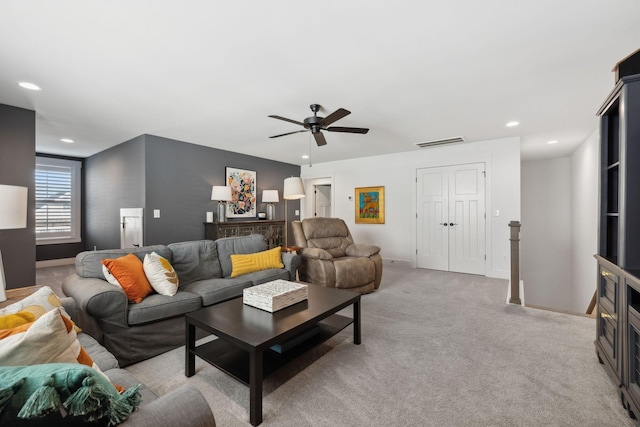 living area with baseboards, visible vents, a ceiling fan, light colored carpet, and recessed lighting