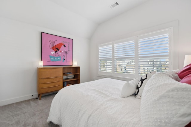 carpeted bedroom featuring visible vents, vaulted ceiling, and baseboards