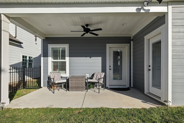 view of patio featuring ceiling fan and fence