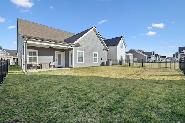 rear view of property featuring ceiling fan, a patio, a fenced backyard, central air condition unit, and a yard