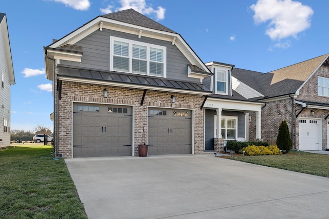 view of front of property featuring driveway, a standing seam roof, and brick siding