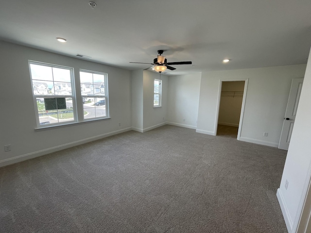 carpeted spare room featuring recessed lighting, visible vents, ceiling fan, and baseboards