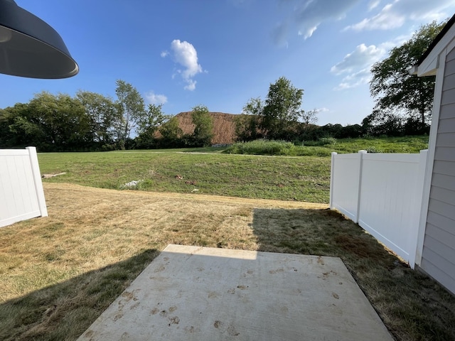 view of yard featuring a patio and fence