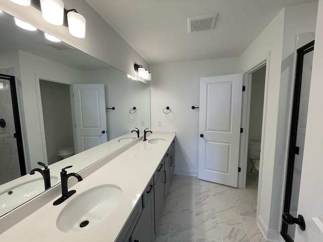 full bath with marble finish floor, visible vents, a sink, and toilet