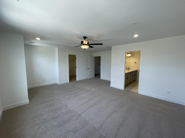 unfurnished bedroom with baseboards, recessed lighting, and light colored carpet