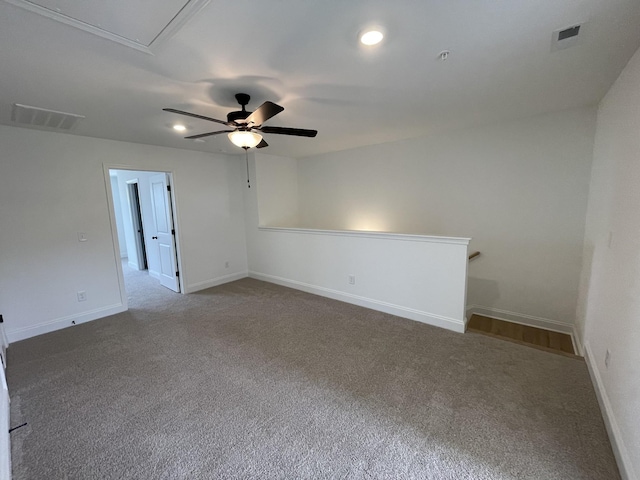 unfurnished room with carpet, visible vents, ceiling fan, and baseboards