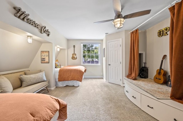 bedroom featuring light carpet, ceiling fan, and baseboards