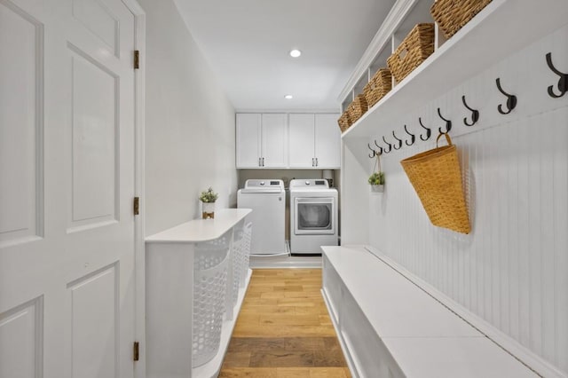 mudroom with light wood finished floors, recessed lighting, and washer and dryer