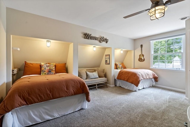 carpeted bedroom with a ceiling fan, visible vents, and baseboards