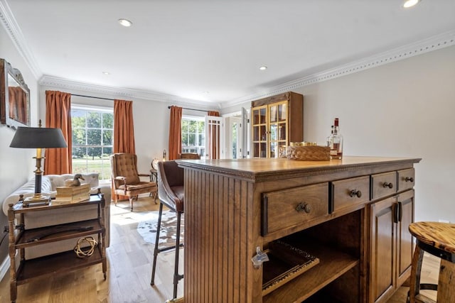 bar featuring ornamental molding, light wood-type flooring, and recessed lighting