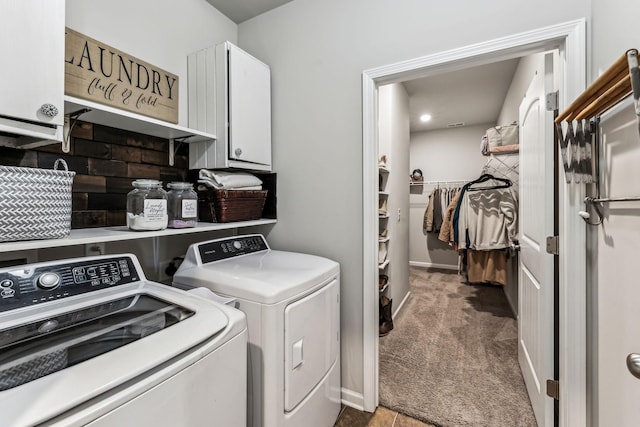 clothes washing area with carpet floors, washer and dryer, cabinet space, and baseboards