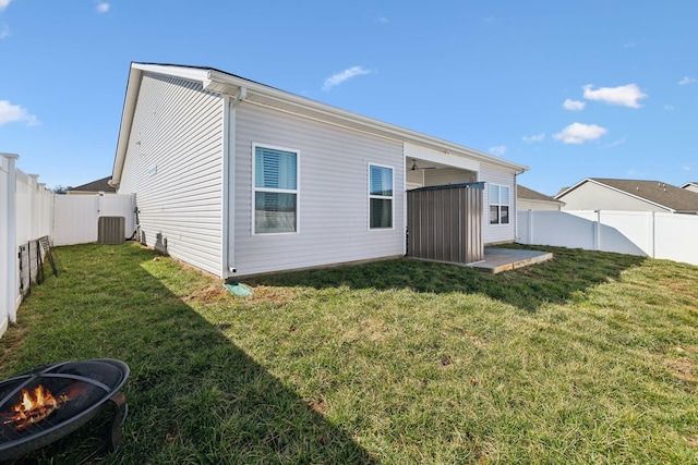 back of property featuring a yard, a fenced backyard, and central air condition unit