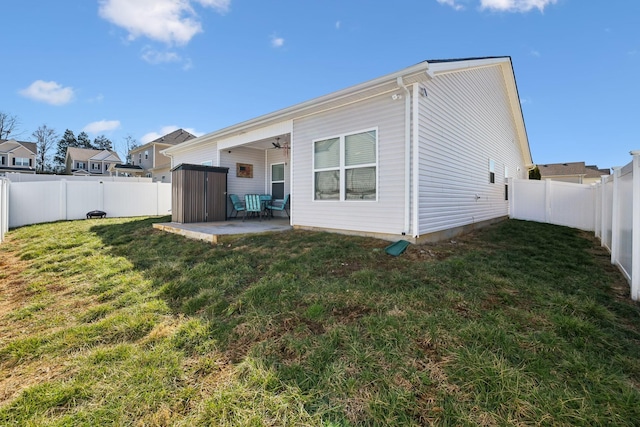 rear view of house with a yard, a fenced backyard, a patio, and ceiling fan