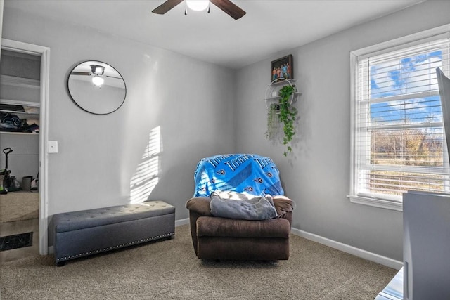 living area with carpet, ceiling fan, and baseboards