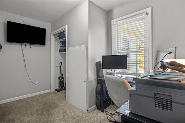 carpeted home office featuring baseboards