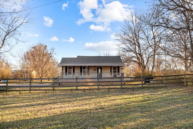 farmhouse-style home with covered porch and a fenced front yard