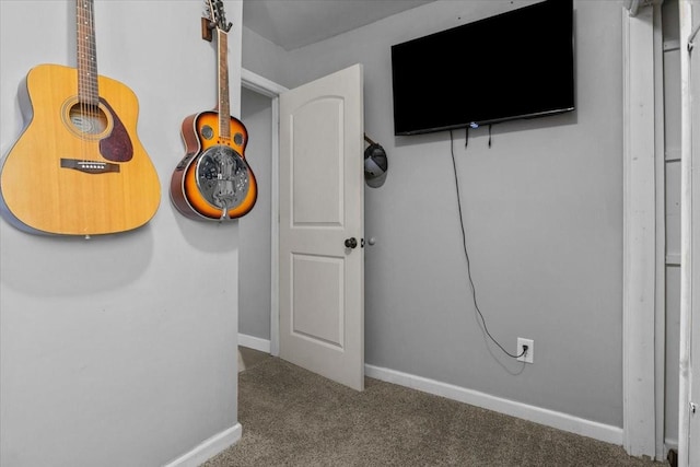 interior space featuring carpet floors and baseboards