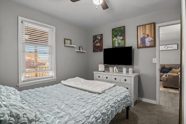 bedroom with light carpet, ceiling fan, and baseboards