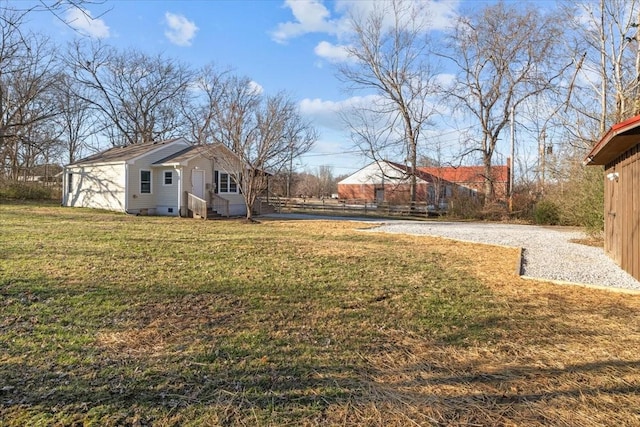 view of yard featuring entry steps and fence