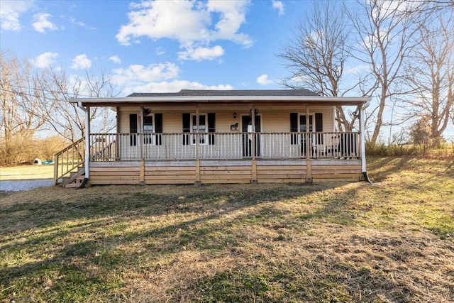 view of front of home with a porch and a front yard