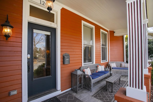 view of exterior entry with covered porch