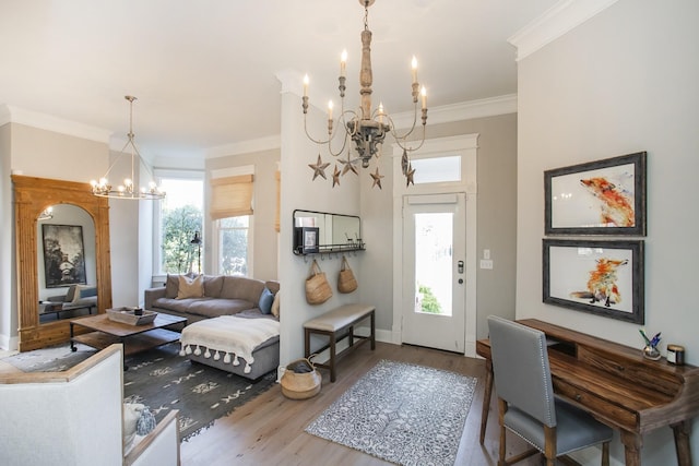 entrance foyer with a chandelier, ornamental molding, wood finished floors, and baseboards