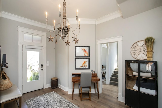 foyer entrance with stairway, an inviting chandelier, ornamental molding, wood finished floors, and baseboards