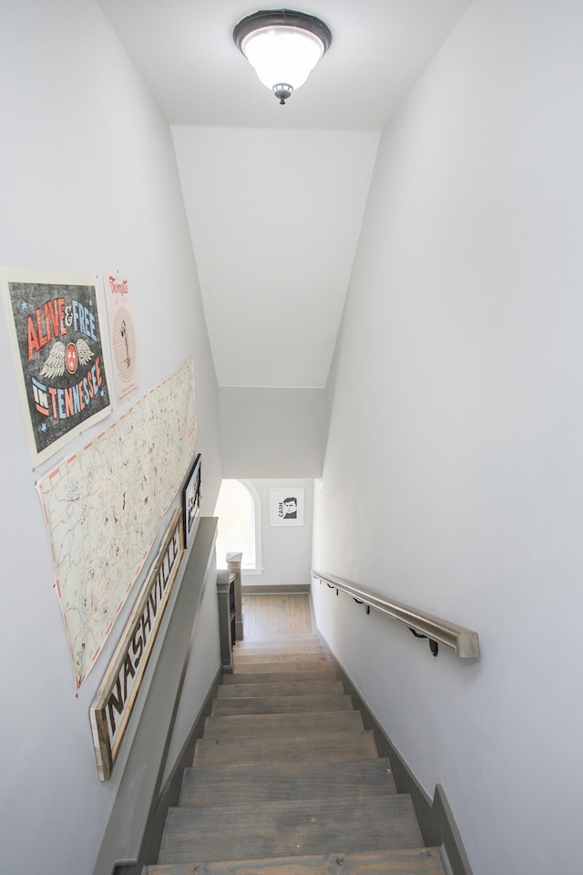 stairs featuring baseboards and wood finished floors