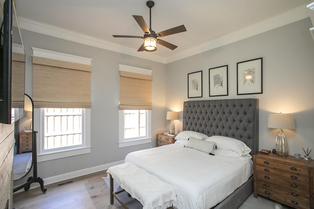 bedroom with baseboards, visible vents, a ceiling fan, ornamental molding, and wood finished floors