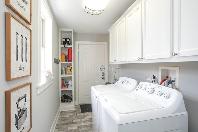 laundry room featuring a wealth of natural light, washing machine and dryer, cabinet space, and baseboards