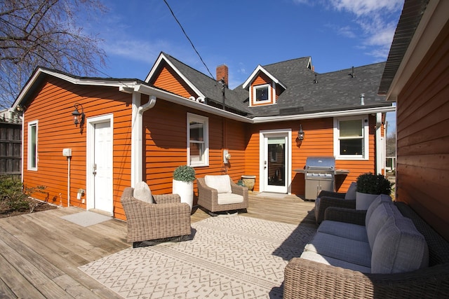 wooden terrace featuring outdoor lounge area and area for grilling