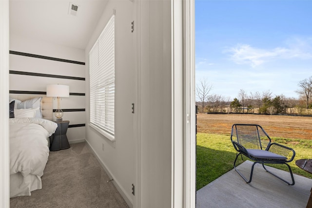 carpeted bedroom with visible vents and baseboards