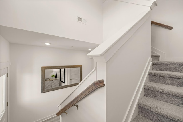 staircase featuring recessed lighting, visible vents, and baseboards