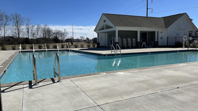 pool featuring fence and a patio