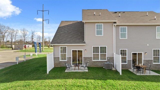 back of property featuring a yard, central AC unit, and a patio