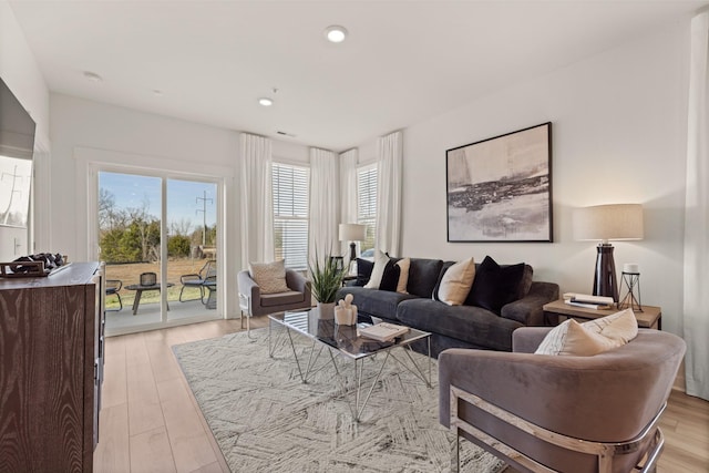 living area featuring light wood-style flooring and recessed lighting