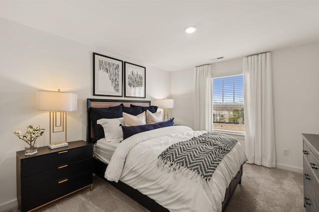 carpeted bedroom with visible vents and baseboards