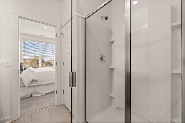 ensuite bathroom with recessed lighting, a shower stall, ensuite bathroom, and tile patterned floors