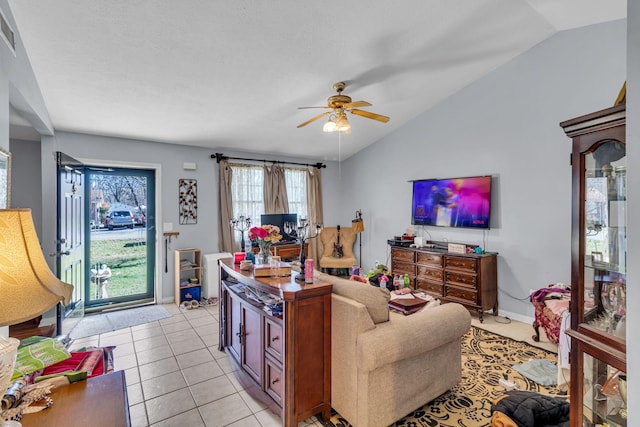 living area with lofted ceiling, light tile patterned floors, baseboards, and a ceiling fan