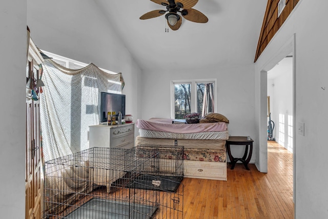 bedroom with high vaulted ceiling and hardwood / wood-style floors