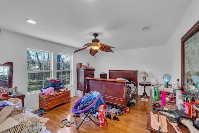 bedroom with baseboards, visible vents, ceiling fan, wood finished floors, and recessed lighting