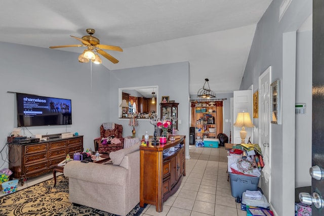 living area with a ceiling fan, light tile patterned flooring, and vaulted ceiling