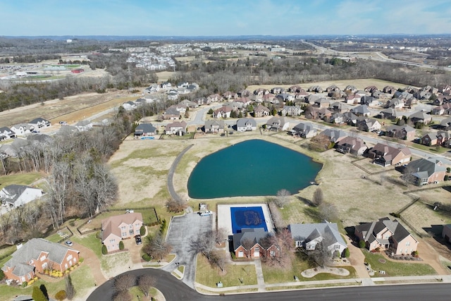 birds eye view of property with a water view and a residential view