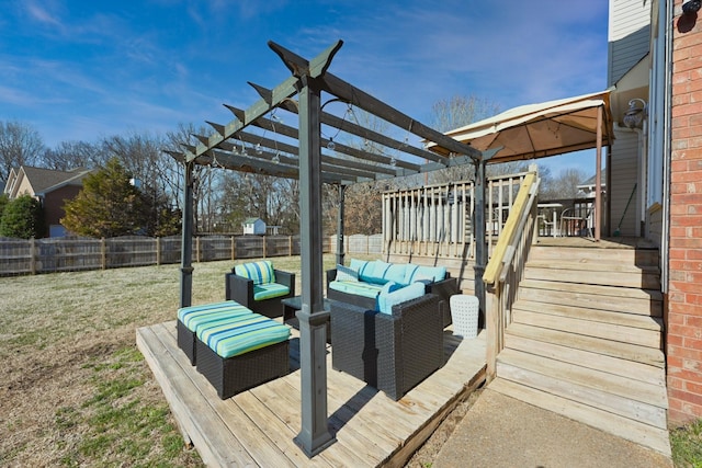 wooden terrace with outdoor lounge area, a yard, a fenced backyard, and a pergola