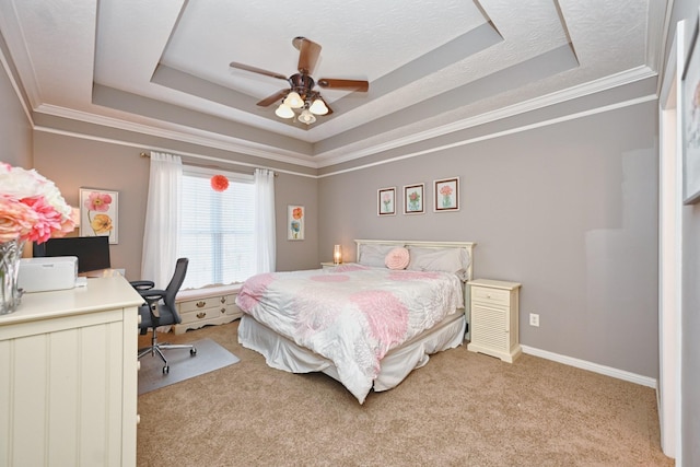 bedroom featuring baseboards, a tray ceiling, ornamental molding, and light colored carpet